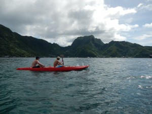 American Samoa - Boys Kayaking Looking at Rainmaker Mountain